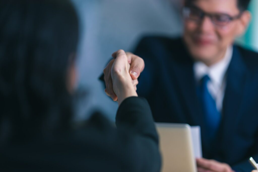 Business, career and placement concept - image from back of two employers sitting in office