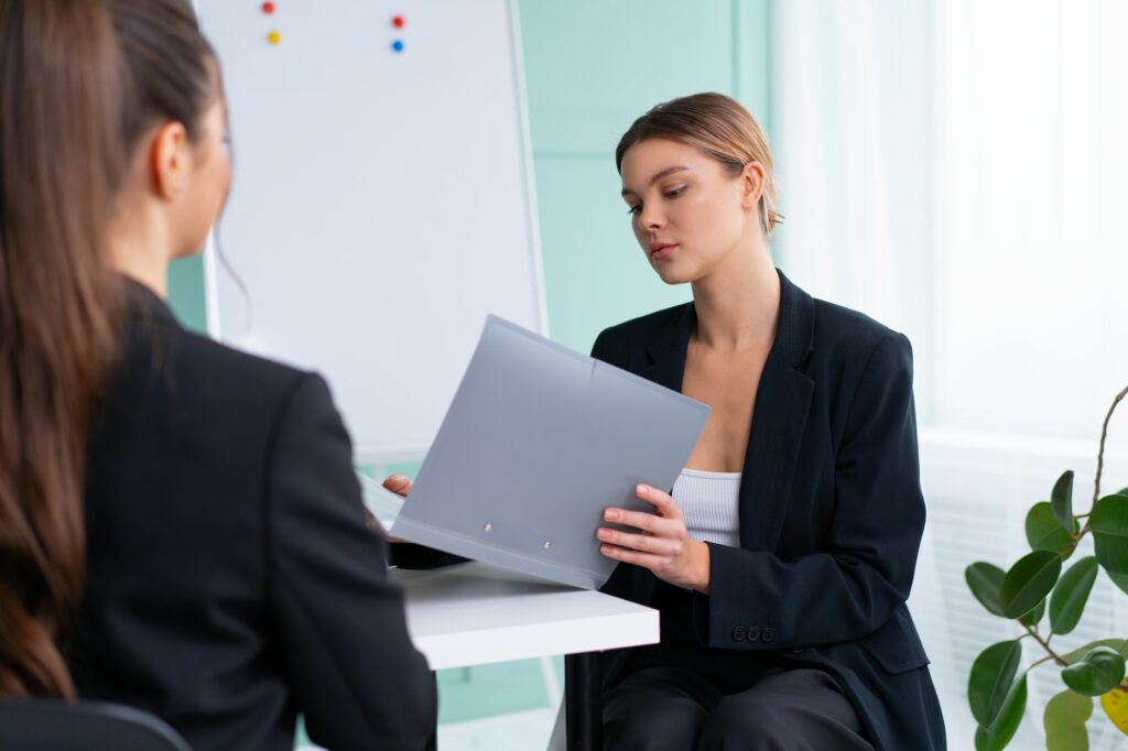 Job interview , Business, career and placement concept. Young blonde woman watching resume